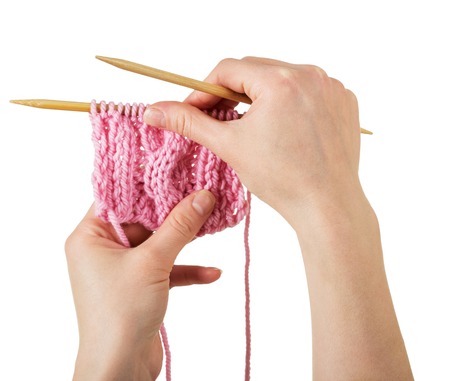 Hobbies, pattern hand knitting in womans hands isolated on whiteの写真素材