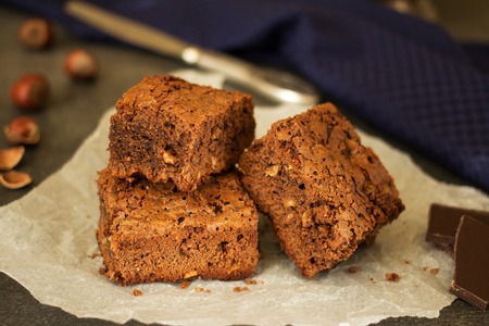 Pieces of cake on parchment, hazelnut and chocolateの写真素材