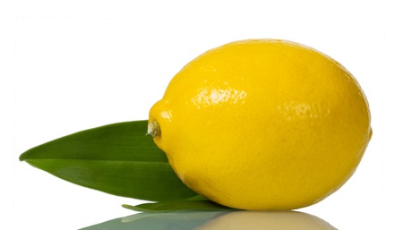 Ripe, juicy lemon with leaf isolated on whiteの写真素材