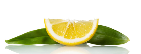Small juicy piece of lemon with leaves isolated on whiteの写真素材