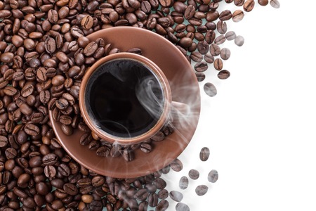 Steam over Cup of hot coffee, scattered coffee beans isolated on whiteの写真素材