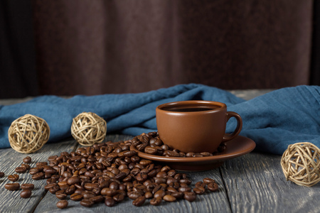Scattered coffee beans, Cup with drink, rope balls, on background of fabricの写真素材