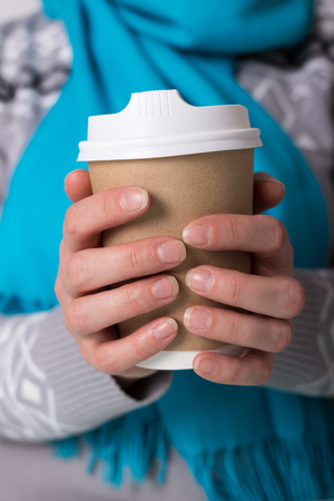 Cup-thermal for coffee to take away, in hands of womenの写真素材