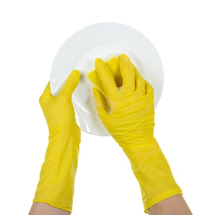 Womens hands with gloves wash sponge plate, isolated on whiteの写真素材