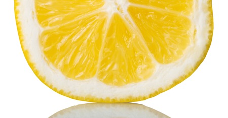 Half of juicy lemon close-up, isolated on whiteの写真素材