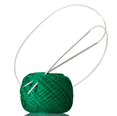 Hank of green cotton yarn and knitting needles isolated on white backgroundの写真素材