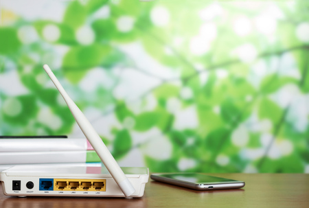 Panel with sockets for modem connection, next to smartphone on light backgroundの写真素材