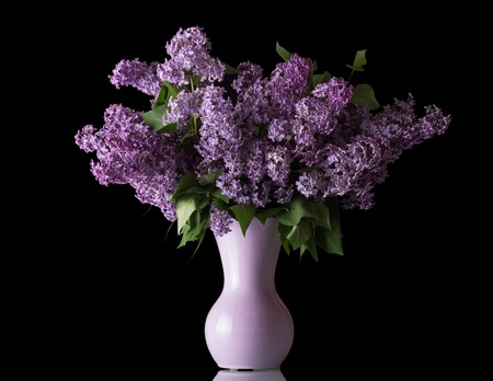 Luxury bouquet of lilac in vase isolated on blackの写真素材