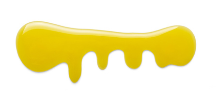 Flowing puddle of liquid sweet honey isolated on whiteの写真素材