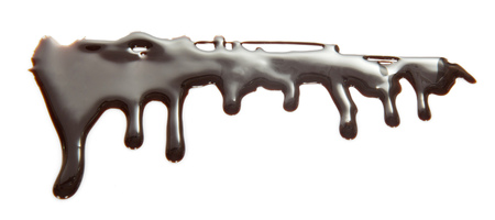Flows of melted chocolate of bizarre shape isolated on whiteの写真素材