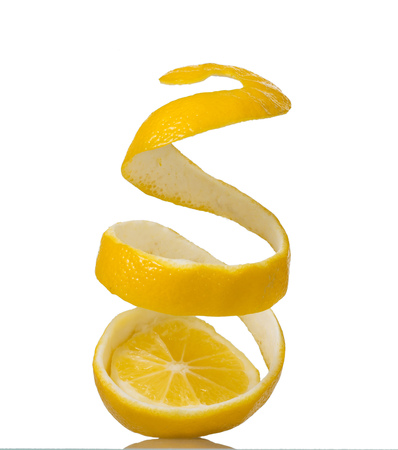 Spiral peel with zest, cutting with lemon, isolated on whiteの写真素材