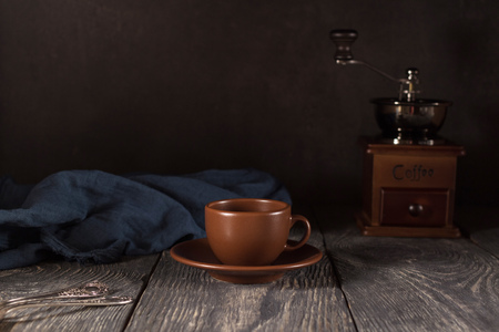 Ceramic Cup and saucer, teaspoons, hand mill for coffee, on black backgroundの写真素材