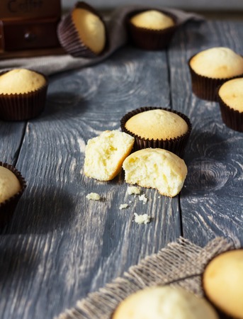 Freshly baked cupcakes are laid on wooden surfaceの写真素材