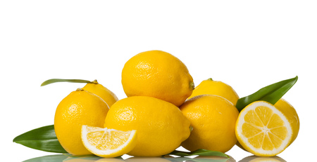 Large yellow fruit and pieces of cut lemon isolated on whiteの写真素材