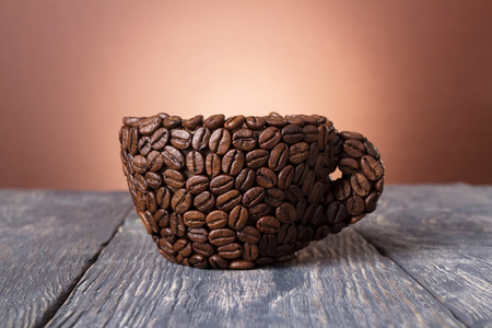 Original coffee Cup of beans on gray tableの写真素材