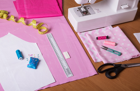 Sewing machine, paper sample on fabric and scissorsの写真素材