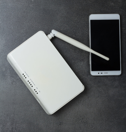 Smartphone and device to wirelessly connect to Internet on grayの写真素材