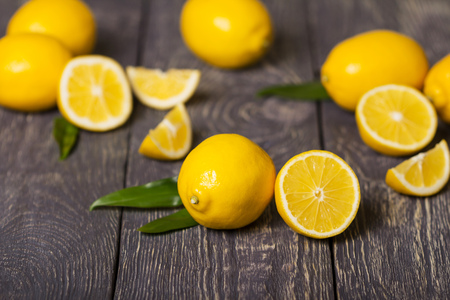 Whole lemon and half in foreground, then lot of citrus, on gray surfaceの写真素材
