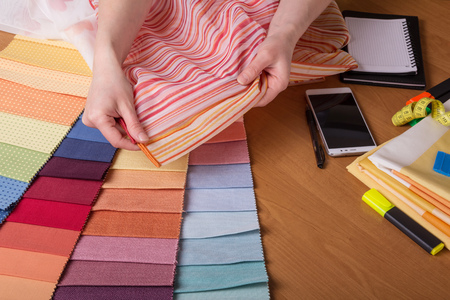 Fabric samples on table, selection of colourの写真素材