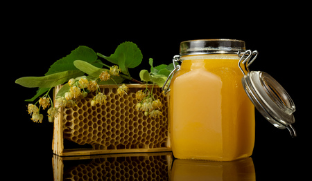 Honey in jar and bee products isolated on blackの写真素材