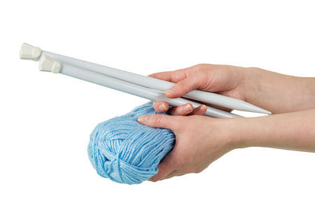 Skein of blue yarn and thick spokes in womans hands isolated on whiteの写真素材