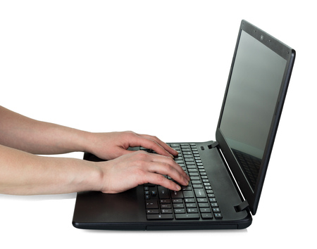 Human hands on computer keyboard isolated on whiteの写真素材