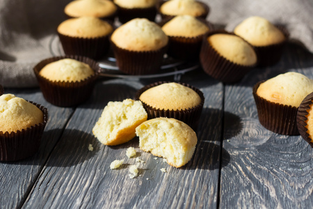 Lot of fresh rosy cupcakes in molds spread out on gray surfaceの写真素材