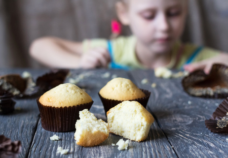 Freshly baked delicious cupcake broken on grey surfaceの写真素材