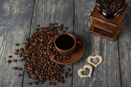 Coffee beans on table and in coffee grinder, Cup with drinkの写真素材