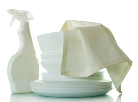 A stack of clean washed dishes, bottle of detergent and napkin isolated on whiteの写真素材