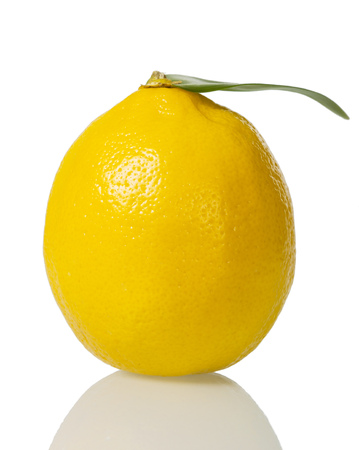 Large bright lemon with leaf isolated on whiteの写真素材
