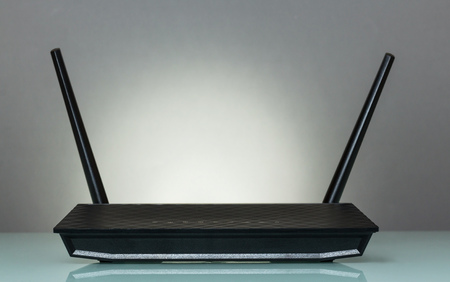 Router for wireless connection of devices to the Internet, on grayの写真素材