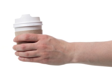 Hot morning take-away coffee in female hand, isolated on whiteの写真素材