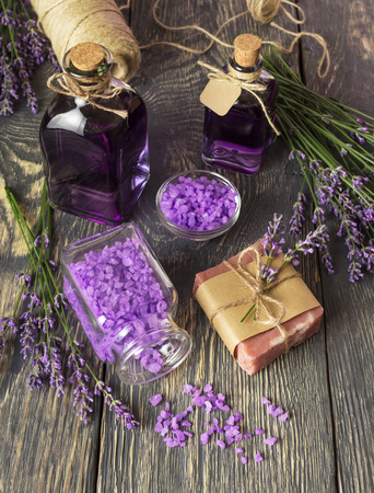 Bottles with lavender infusion closed with cork, soap and sea salt, close-upの写真素材