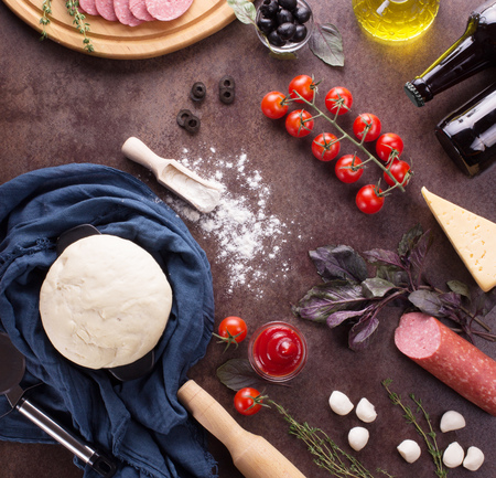 Finished dough and ingredients for pizzaの写真素材