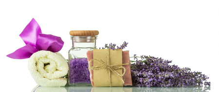 Sea salt with lavender scent, handmade soap and towel isolated on whiteの写真素材
