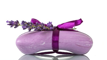 Soap with lavender scent, purple ribbon isolated on whiteの写真素材