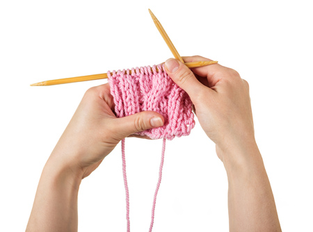 Female hands knit warm pink scarfの写真素材