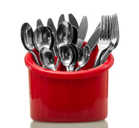 Kitchen accessories in a red dryer isolated on a white backgroundの写真素材