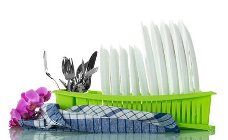 Clean washed kitchen utensils in drying isolated on whiteの写真素材
