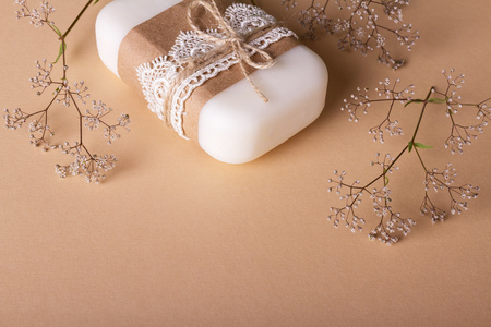 Handmade soap decorated with delicate lace on a beige backgroundの写真素材