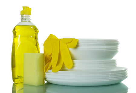 A stack of clean washed dishes and dish detergent isolated on white backgroundの写真素材