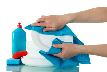 Hands are wiping blue towel on a clean plate isolated on a white backgroundの写真素材
