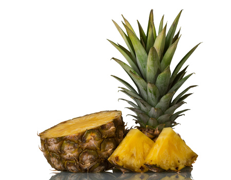 Juicy fresh pineapple cut into slices isolated on white backgroundの写真素材