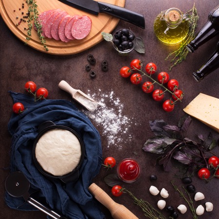 Set of pepperoni pizza ingredients on a dark table. Flat layの写真素材