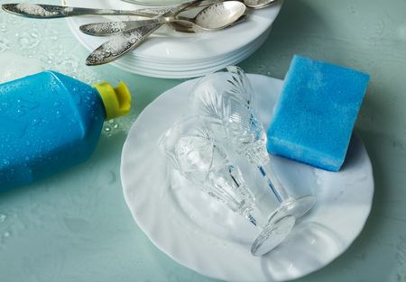 Clean dishes in the foam detergent for washing dishes, blue spongeの写真素材