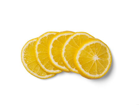 Five sliced fresh juicy lemon rings isolated on white backgroundの写真素材