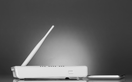 White router and a smartphone on a bright beautiful gray backgroundの写真素材