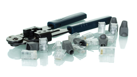 Crimping tool for twisted pair network cable with connectors and caps isolated on white backgroundの写真素材