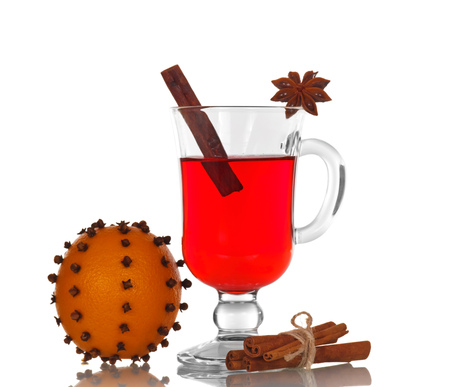 Hot spiced mulled wine and orange flowered carnations isolated on white backgroundの写真素材